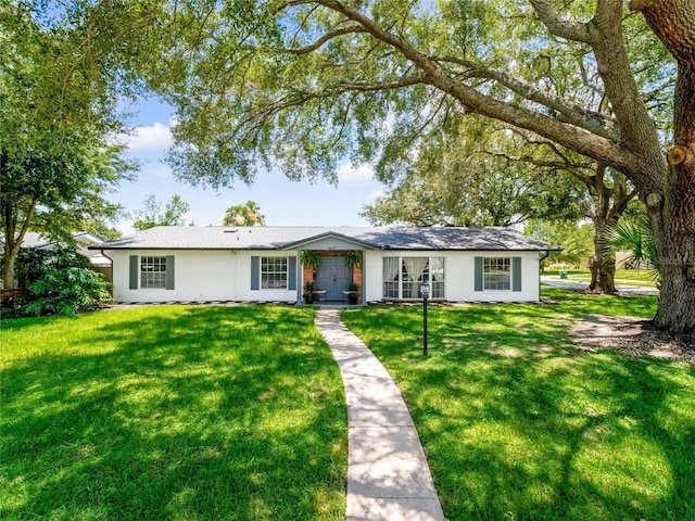 single story home with a front lawn and stucco siding