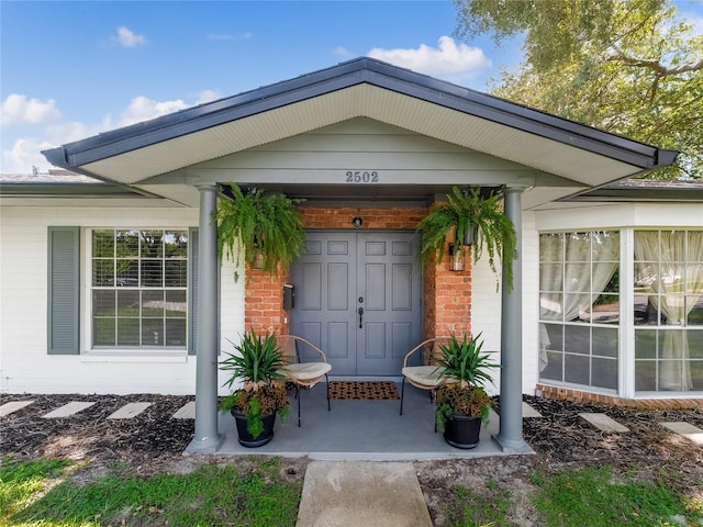 entrance to property with brick siding