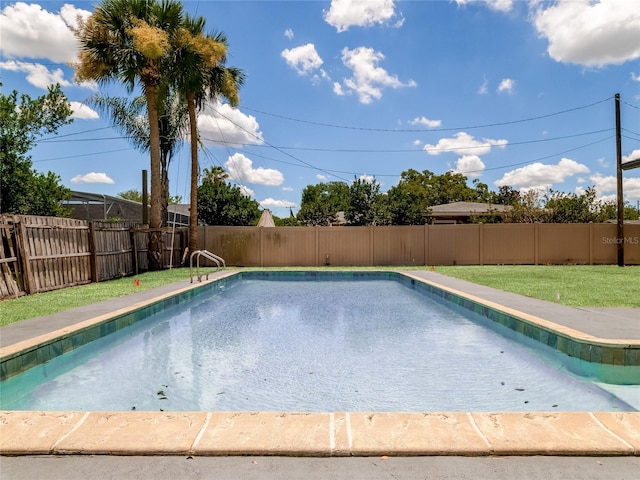 view of pool with a fenced in pool, a fenced backyard, and a lawn