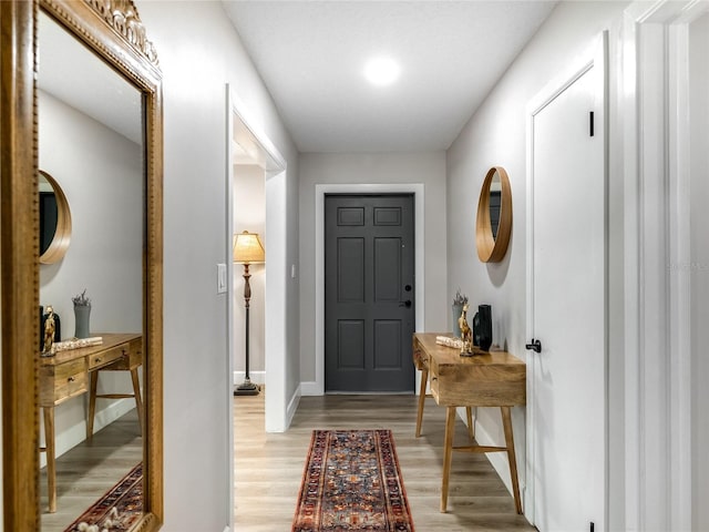 entryway featuring light wood-type flooring and baseboards