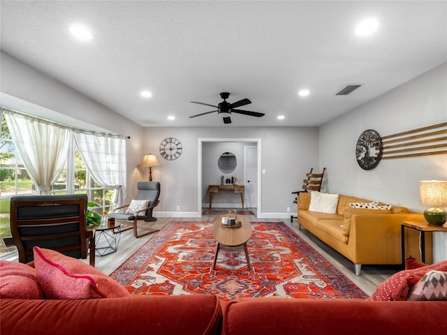 living area featuring recessed lighting, visible vents, ceiling fan, wood finished floors, and baseboards