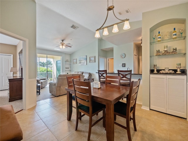 dining room with vaulted ceiling, ceiling fan, and light tile floors