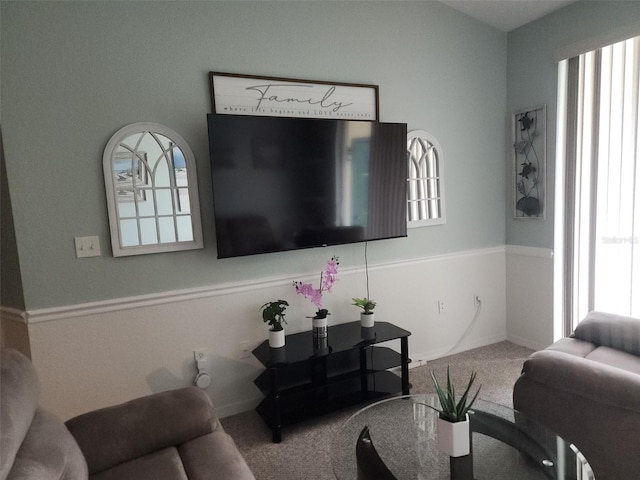 living room featuring carpet and plenty of natural light