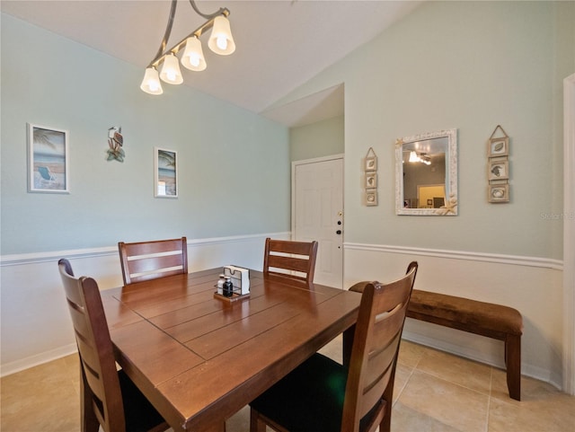 dining room with tile floors and vaulted ceiling