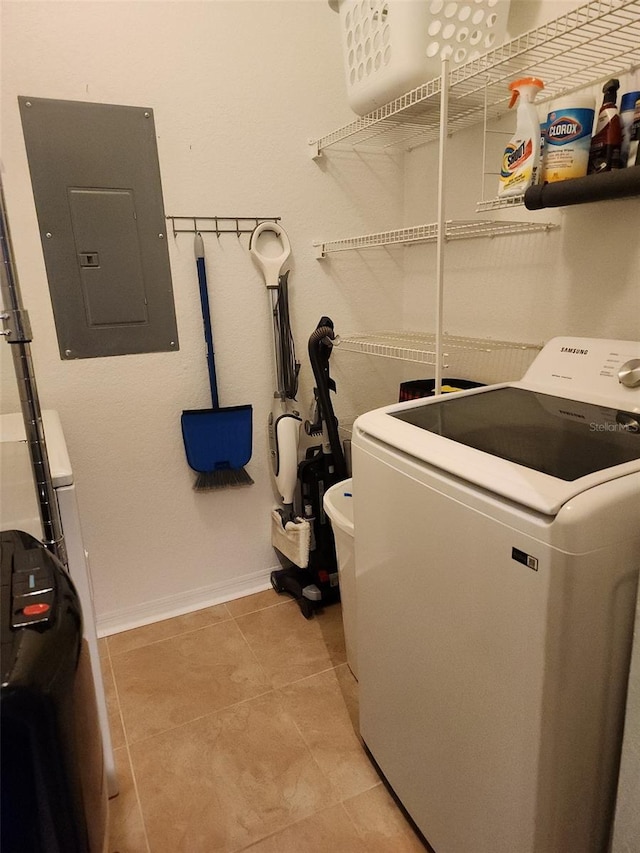 laundry area featuring light tile floors and washer / clothes dryer