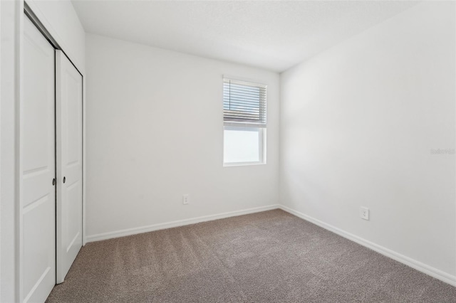 unfurnished bedroom featuring a closet and carpet floors