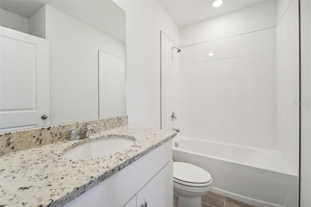 full bathroom with toilet, vanity, tile patterned floors, and tiled shower / bath combo