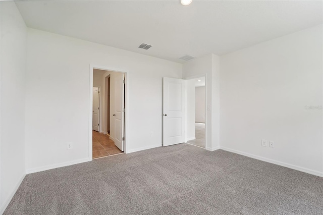 unfurnished bedroom featuring light colored carpet