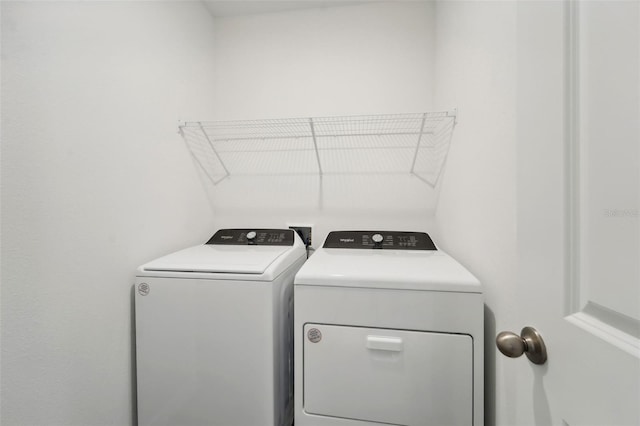 washroom featuring washer and clothes dryer