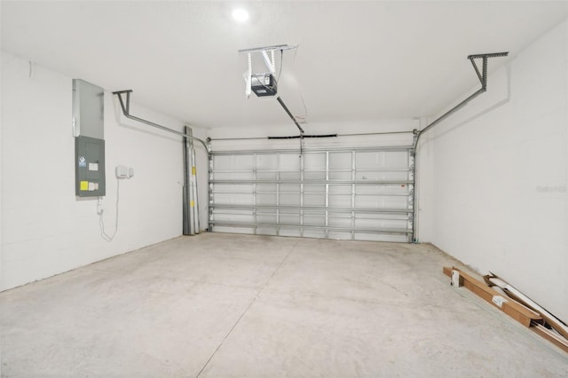 garage with a garage door opener and electric panel