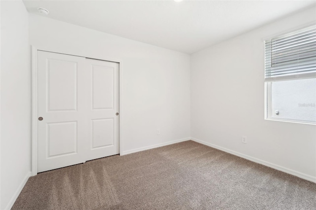 unfurnished room featuring carpet flooring