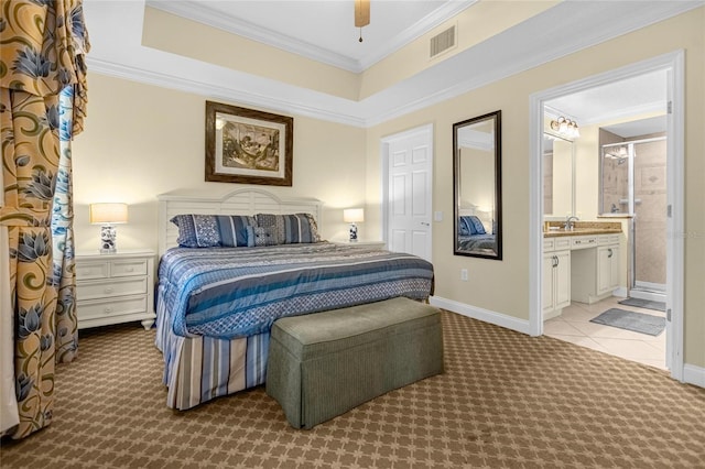 bedroom with ensuite bath, light colored carpet, ceiling fan, and crown molding