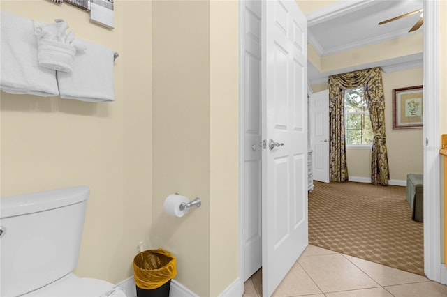 bathroom with toilet, tile patterned flooring, ornamental molding, and ceiling fan