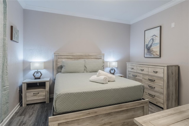 bedroom with ornamental molding and dark hardwood / wood-style flooring