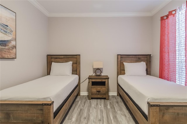 bedroom with crown molding and light hardwood / wood-style flooring