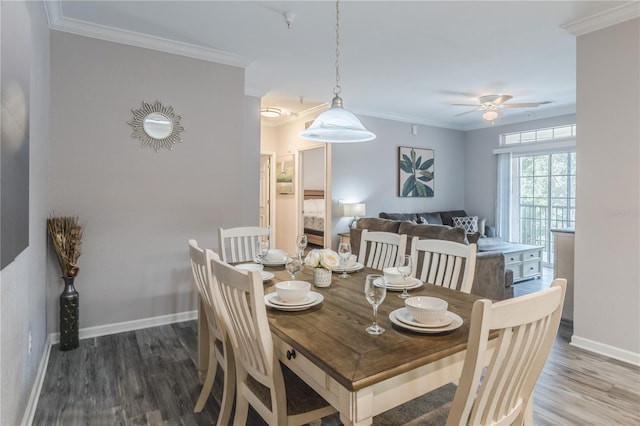 dining room with hardwood / wood-style floors, ceiling fan, and crown molding