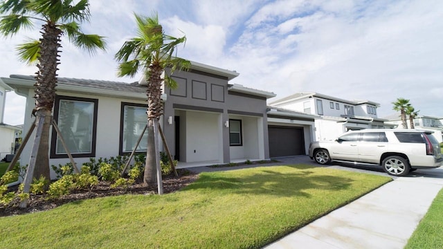 view of front facade featuring a garage and a front lawn