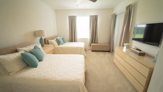 bedroom featuring ceiling fan and light carpet