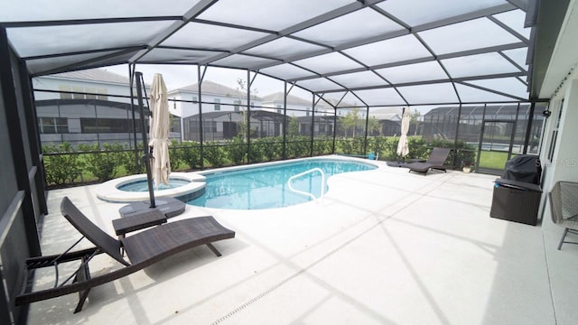 view of swimming pool with glass enclosure, an in ground hot tub, and a patio