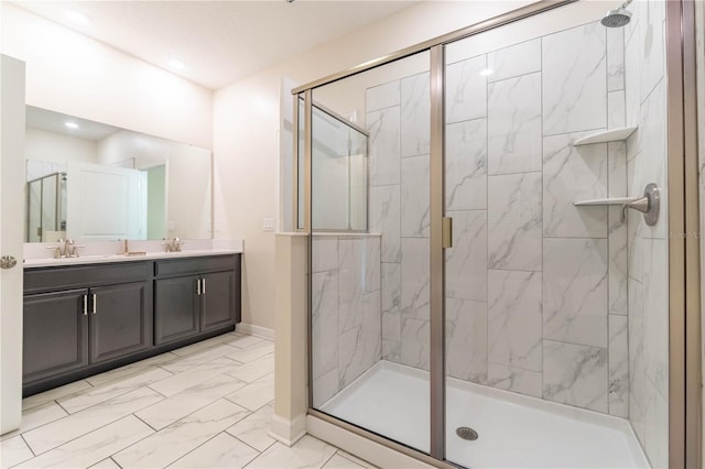 bathroom featuring walk in shower and vanity