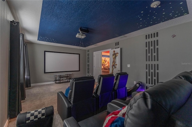 home theater featuring a textured ceiling, a raised ceiling, and carpet floors