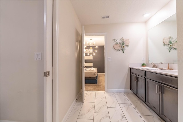 bathroom featuring vanity and a notable chandelier