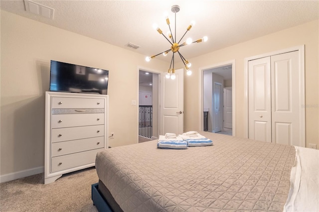 carpeted bedroom with a textured ceiling, a closet, and a notable chandelier