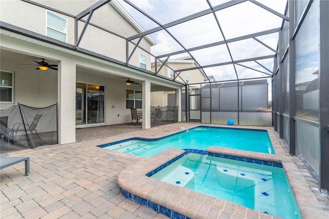 view of pool with a patio area, a lanai, ceiling fan, and an in ground hot tub