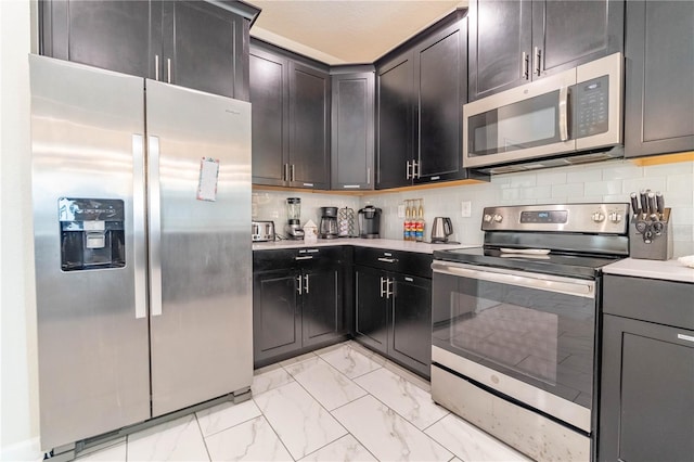 kitchen with backsplash and appliances with stainless steel finishes