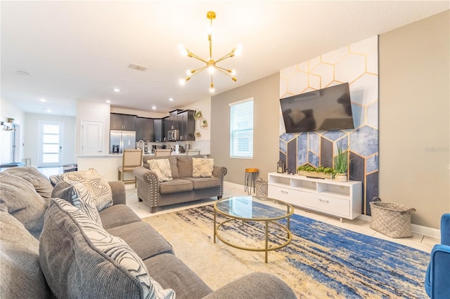 living room featuring a notable chandelier and light tile patterned floors