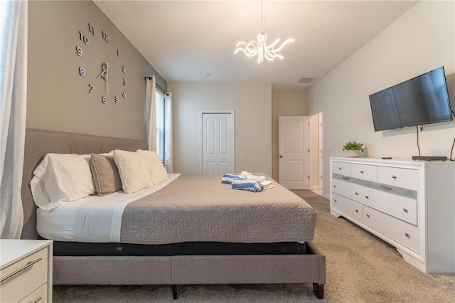 carpeted bedroom with a chandelier and a closet