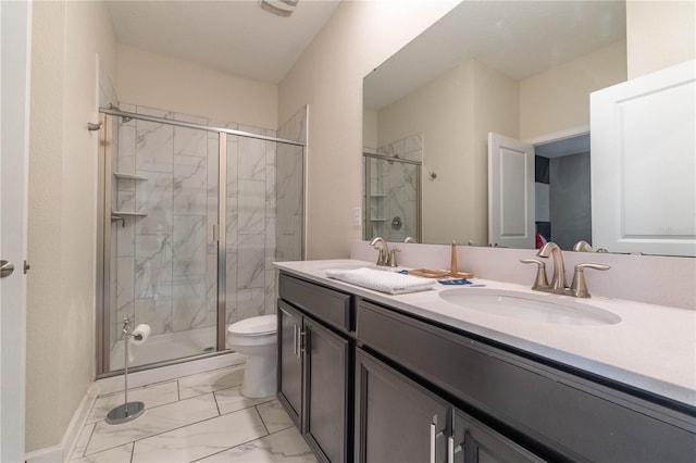 bathroom featuring vanity, toilet, and a shower with shower door