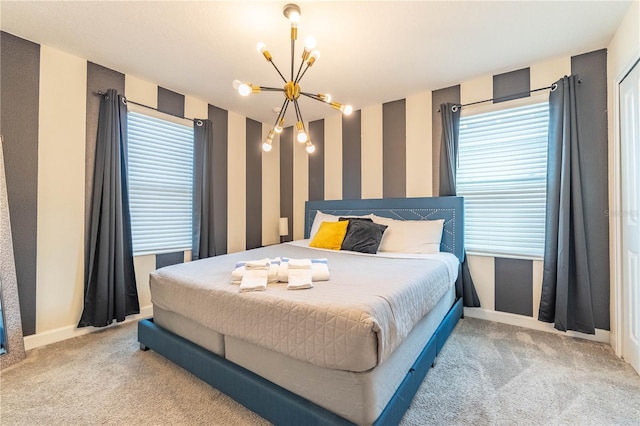 carpeted bedroom with multiple windows and a chandelier