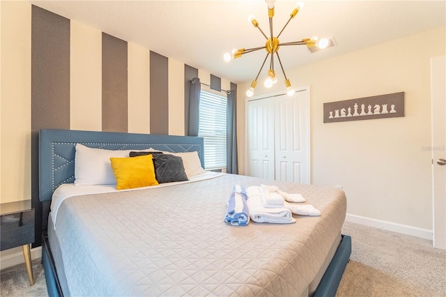 carpeted bedroom with a closet and a notable chandelier