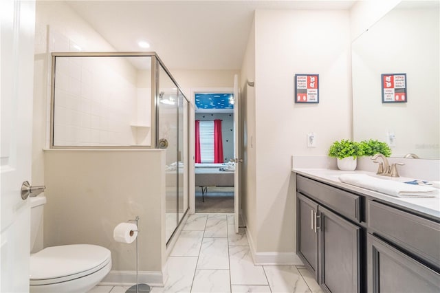 bathroom featuring toilet, vanity, and a shower with door