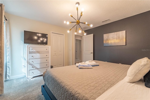 bedroom with carpet floors, a chandelier, and a closet