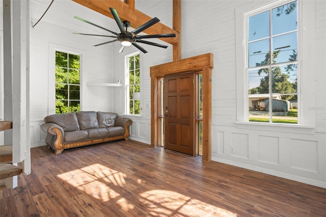 unfurnished room with ceiling fan, beamed ceiling, dark hardwood / wood-style floors, and high vaulted ceiling