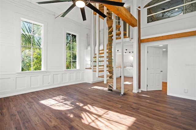 interior space with beam ceiling, high vaulted ceiling, and dark wood-type flooring