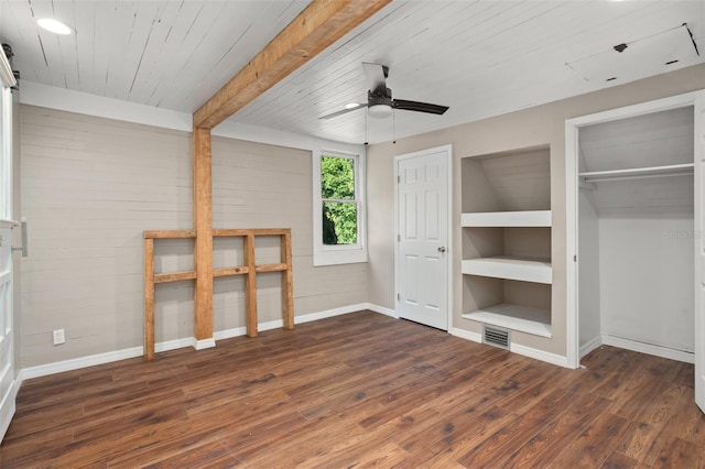 unfurnished bedroom featuring a closet, dark hardwood / wood-style floors, ceiling fan, and wood ceiling