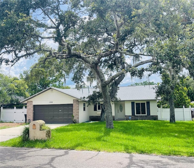 ranch-style house with a front lawn and a garage