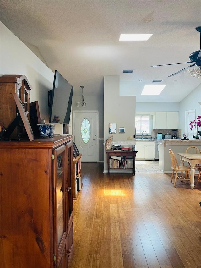 office space featuring sink, ceiling fan, light tile floors, and a textured ceiling