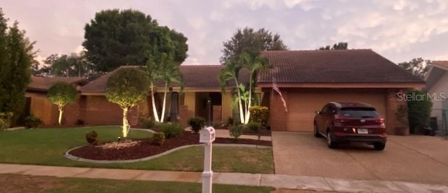 view of front facade with a garage and a lawn