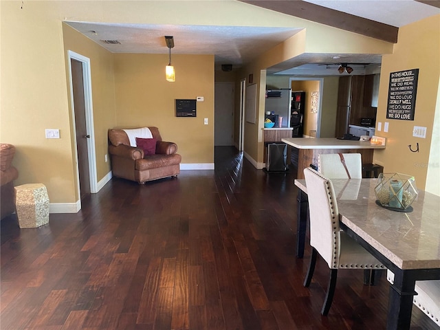 dining area featuring lofted ceiling and dark wood-type flooring