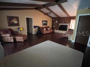 living room with vaulted ceiling with beams and hardwood / wood-style floors