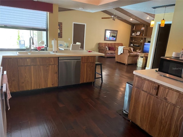 kitchen with hanging light fixtures, stainless steel appliances, dark wood-type flooring, and sink