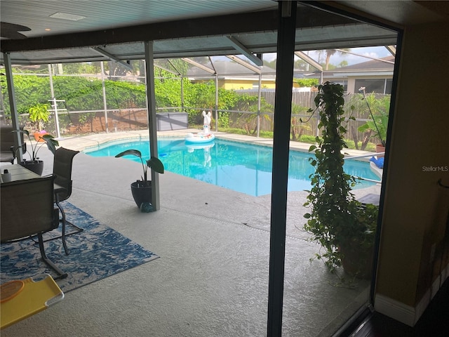 view of pool with a patio area and a lanai