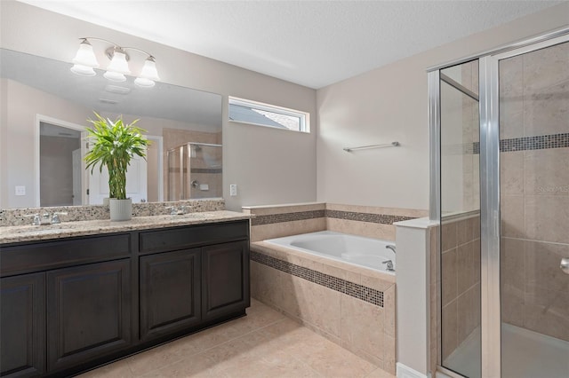 bathroom featuring a textured ceiling, tile patterned flooring, shower with separate bathtub, and vanity