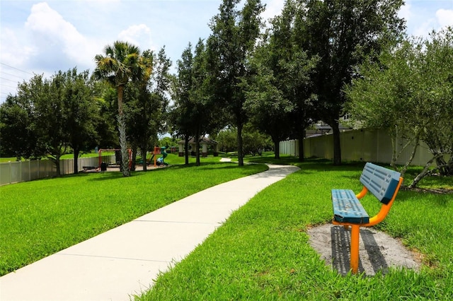 surrounding community with a playground and a yard