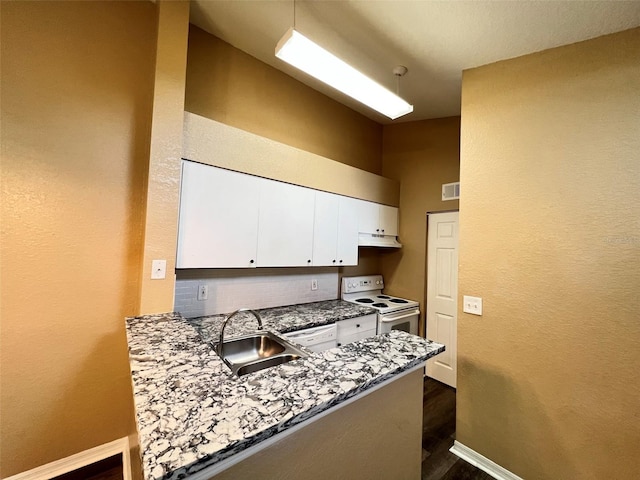 kitchen with electric stove, stone counters, white cabinets, sink, and dark hardwood / wood-style flooring