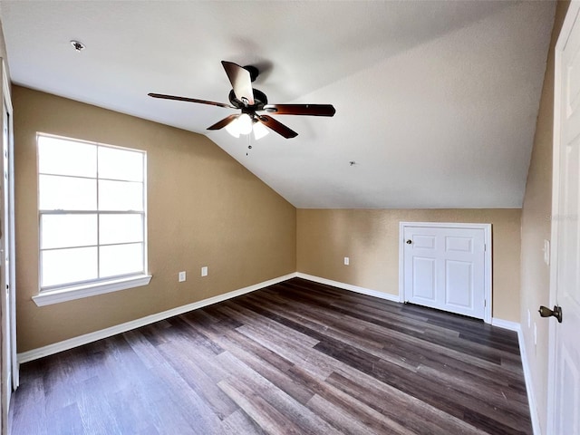 bonus room with dark hardwood / wood-style flooring, ceiling fan, and vaulted ceiling